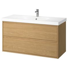 a bathroom vanity with two drawers and a faucet on the top, in light wood