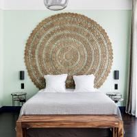 a bedroom with a large circular wall decoration above the bed