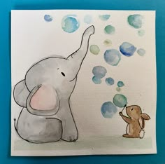 an elephant blowing bubbles next to a little dog on a blue background with watercolor drops