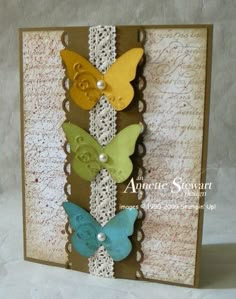 a close up of a card with three butterflies on the front and one butterfly on the back