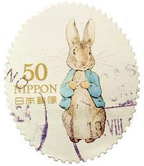 a stamp with an image of a rabbit on it's back and the words 50 nippon written in gold