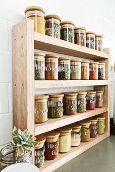 a wooden spice rack filled with lots of spices