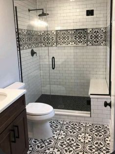 a bathroom with black and white tiles on the floor, shower stall and toilet area