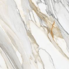 the marble is white and grey with brown streaks on it's edges, as well as gold veining