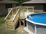 an above ground swimming pool with steps leading up to the deck and stairs on either side