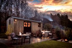 a small wooden shed sitting on top of a lush green field