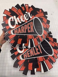 someone is holding up a sticker that says cheer harper and henley on it