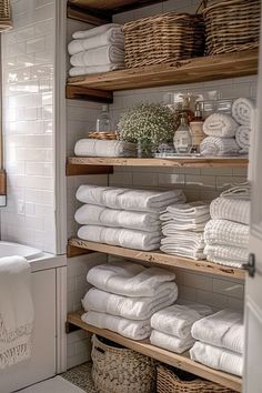 towels are stacked on shelves in the bathroom