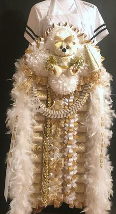 a white shirt with gold and white feathers on it