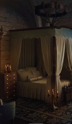 an old fashioned bedroom with four poster bed and candles on the nightstands in front of it