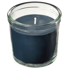 a blue candle is sitting in a glass container