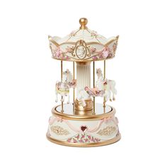 a white and gold carousel with pink flowers on the top is sitting in front of a white background