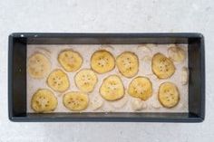 a pan filled with sliced bananas sitting on top of a counter