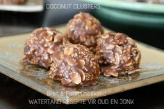 chocolate covered cookies sitting on top of a glass plate