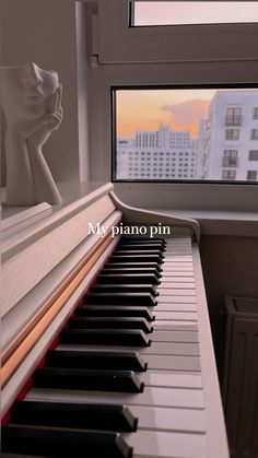 a close up of a piano near a window