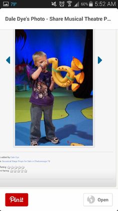 an image of a child playing with stuffed animals in front of a screen capturer