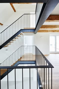 an empty room with wooden floors and white walls is seen from the second floor looking down