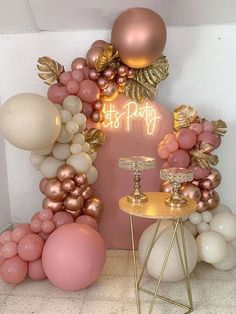 balloons and candles are arranged in front of a pink backdrop that says it's party