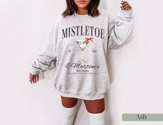 Mistletoe and Martinis Christmas Sweatshirt * Q U I C K * F A C T S * ✺Made with a thick blend of cotton and polyester, it feels plush, soft and warm, a perfect choice for any cold day ✺ Wash and dry on low for best results * S I Z I N G * ✺ Models have sized up for an oversized look | For an oversized look, we recommend sizing up at least 2 sizes ✺ Sizing is unisex so runs like men's, though not overly large ✺ Size guide listed in the listing photos provides exact measurements I * S H I P P I N G * T I M E S * ✺ Our items are individually made with love for each of our buyers. Because of this, our processing time is 2-5 business days (depending on order volume) plus transit time, but typically much faster. We know our customers want their items as quickly as possible! * K E E P * S H O P Expresso Martini, Funny Christmas Sweater, Funny Christmas Sweaters, Christmas Crewneck, Dirty Martini, Christmas Pjs, Espresso Martini, Funny Sweatshirts, Christmas Sweatshirts