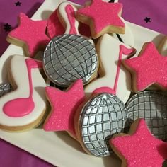 decorated cookies with pink and silver decorations on a plate