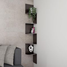 a living room with a gray couch and some shelves on the wall next to it