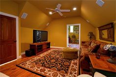 a living room filled with furniture and a flat screen tv