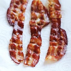 bacon strips sitting on top of a white paper towel next to an advertisement for french cuisine