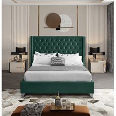 a bedroom with a green headboard and white bedding in the middle of it