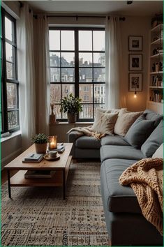 a living room with a couch, coffee table and large windows in it's corner