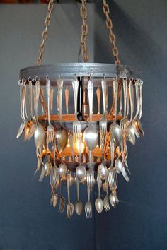 a chandelier with forks and spoons hanging from it