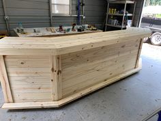 a large wooden box sitting on top of a garage floor