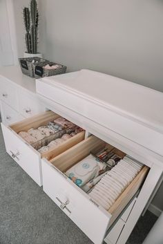 an open dresser drawer with baby items in it