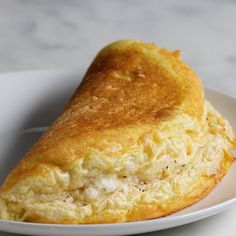 a close up of a plate of food with some sort of pastry on the side