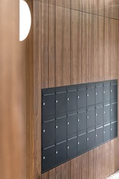 a row of mailboxes mounted to the side of a wall in a building