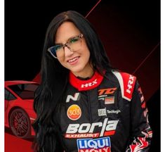 a woman with long black hair and glasses standing in front of a red sports car