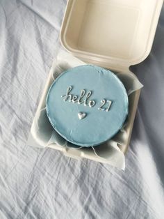 a cake in a box with the word hello 21 written on it and a heart