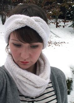 a woman wearing a white knitted headband in the snow