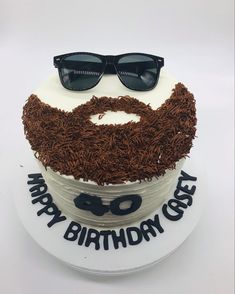 a birthday cake with sunglasses and a beard on it