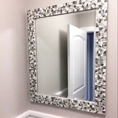 a bathroom mirror sitting on top of a wall