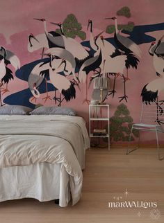 there is a bed with white sheets and pink wallpaper on it, along with birds painted on the walls