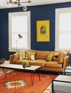 a living room with blue walls and orange carpeted area rugs on the floor