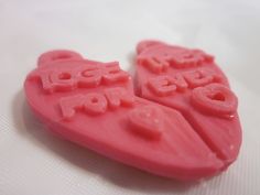 two pieces of pink plastic with the words love for you written in large letters on them