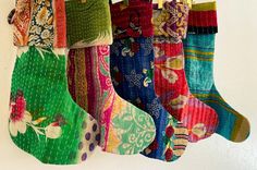 several colorful socks hanging on a white wall