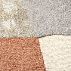 an assortment of different colored rugs on the floor