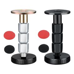 two black and white pedestals with red circles around them, one on top of the other