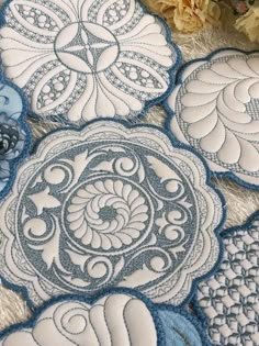 several blue and white circular designs with flowers in the background