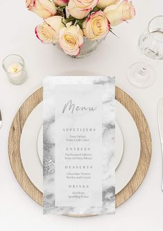 a table setting with place settings and flowers