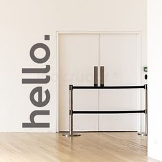 a white room with a black and white logo on the wall