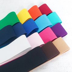 several colors of ribbon are laid out on the table