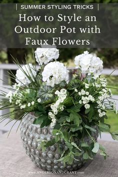 some white flowers in a pot on a table with the words summer styling tricks how to style an outdoor pot with faux flowers